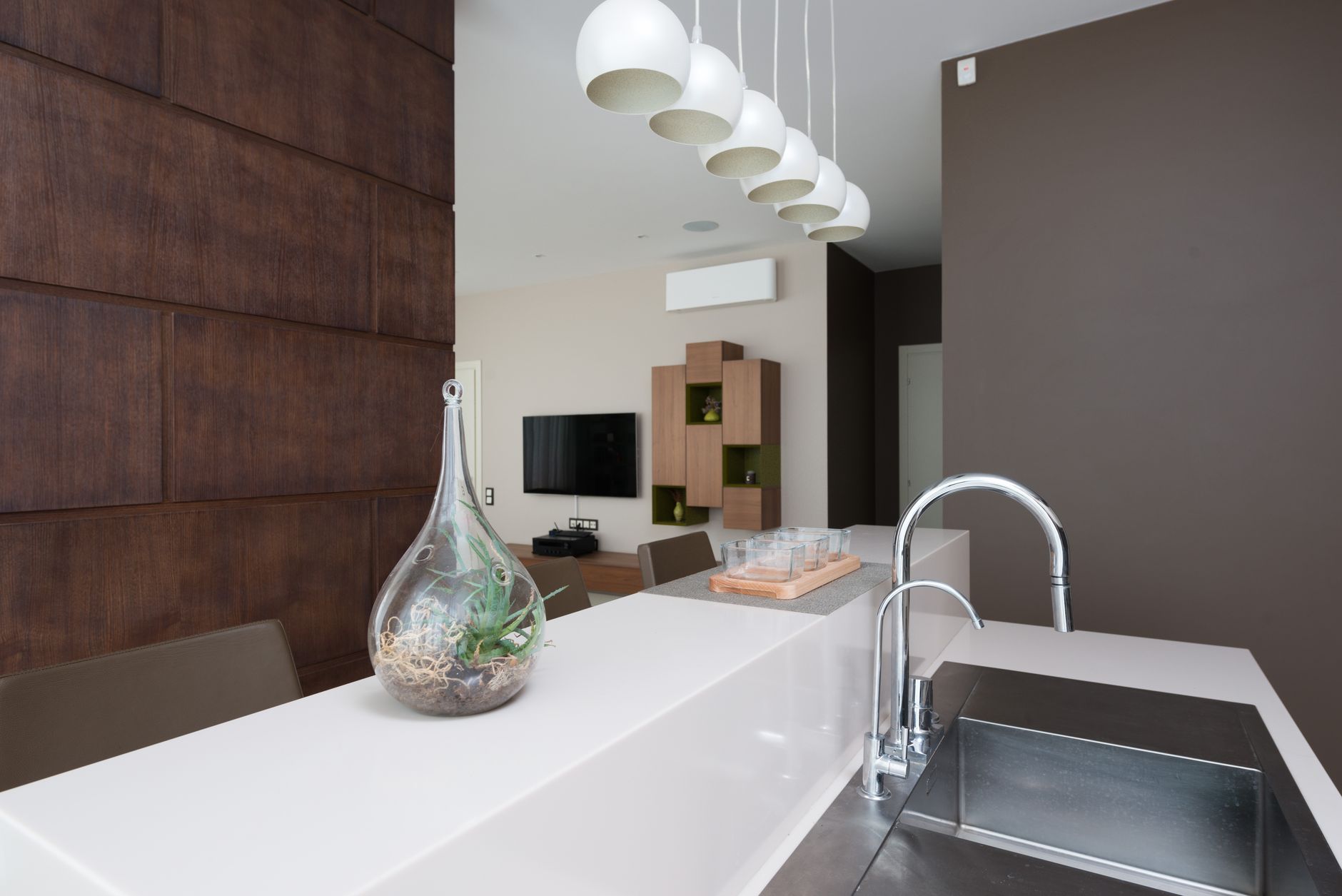 Decorative glass vase placed on white counter near sink with faucet in light modern apartment against in Temecula, CA